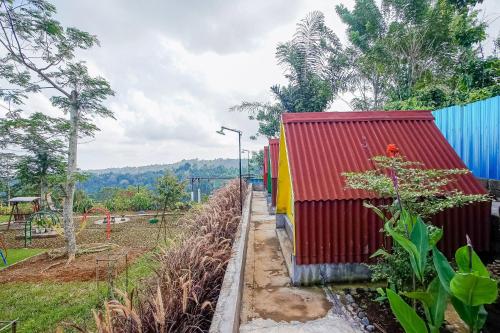 a train yard with a red and yellow train at Rainbow Glamping in Padangan