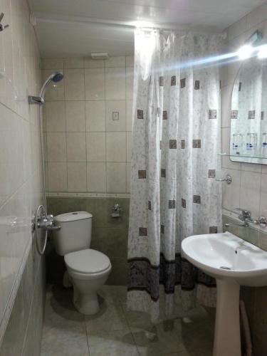 a bathroom with a toilet and a sink at Rai Hotel in Kavarna