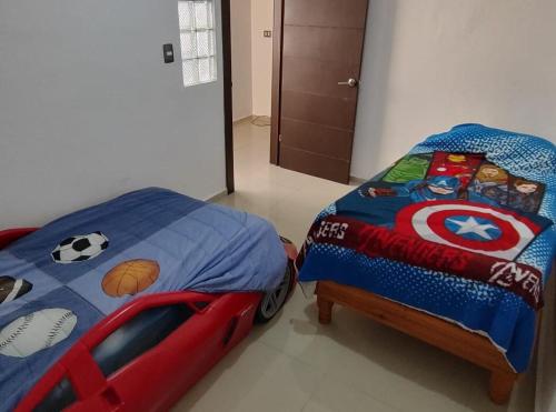 a bedroom with a bed with a superman comforter at Casa 2 habitaciones más sofá in Delicias