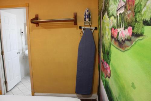 a bathroom with a blue tie hanging on a wall at City Center Motel Indio in Indio