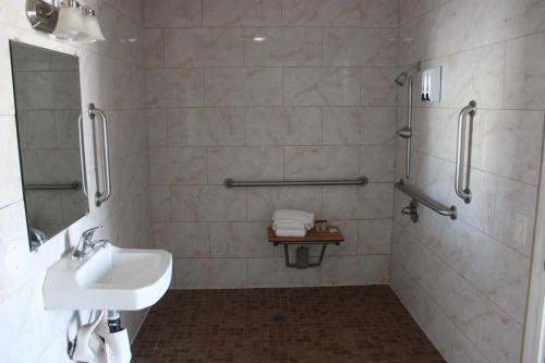 a bathroom with a sink and a shower at City Center Motel Indio in Indio