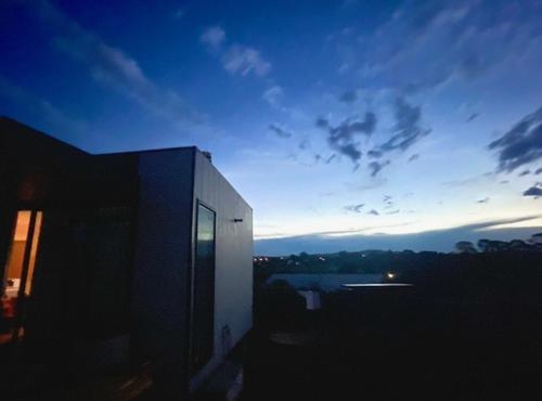 a view of a building with a sunset in the background at The Mod Clunes in Clunes