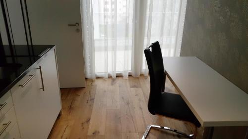 a black chair sitting at a desk in a kitchen at Residence Appartements in Zürich