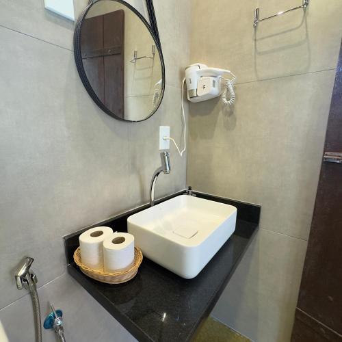 a bathroom with a sink and a mirror at Pousada Cristal da Terra in Sao Jorge