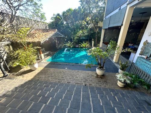 a swimming pool in front of a house at Colonial Retreat Villa in Talawatugoda