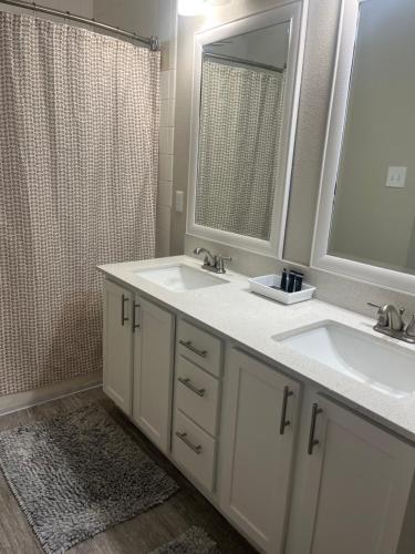 a bathroom with two sinks and a shower at Resort Style Apt/Home in Houston Medical Centre in Houston