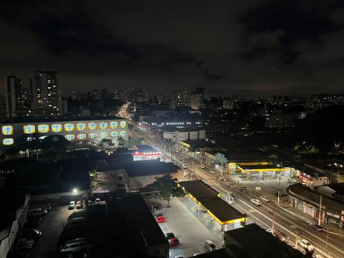 a city street at night with cars and buildings at Apartamento com espaço de trabalho completo - Estação João Dias CPTM in Sao Paulo