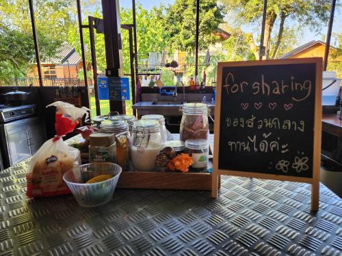 a food stand with a sign on a table at Hindad Nature Resort in Ban Ni Khu Hu