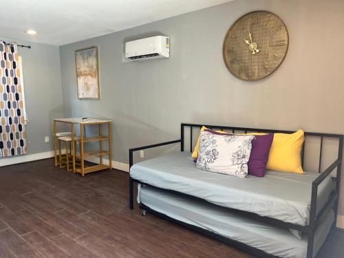 a bedroom with a bed with a clock on the wall at Chic & Cozy 1-bedroom Apartment with Free Parking in Houston