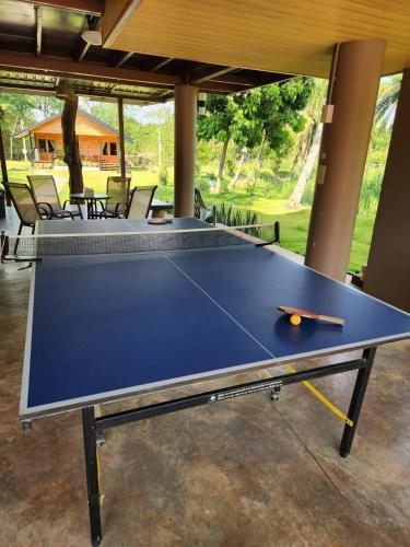 a blue ping pong table in a room with chairs at Hindad Nature Resort in Ban Ni Khu Hu