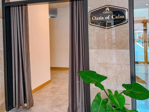 a glass door with a sign for a class of claim at The Glory Hotel and Residence Clark Pampanga in Mabalacat