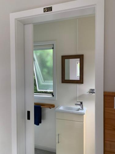 a bathroom with a sink and a window at Abel Tasman Haven in Marahau
