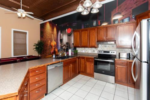 a large kitchen with wooden cabinets and appliances at The Jazz Club Downtown Sandusky in Sandusky