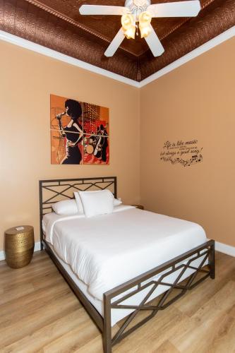 a bedroom with a bed and a ceiling fan at The Jazz Club Downtown Sandusky in Sandusky