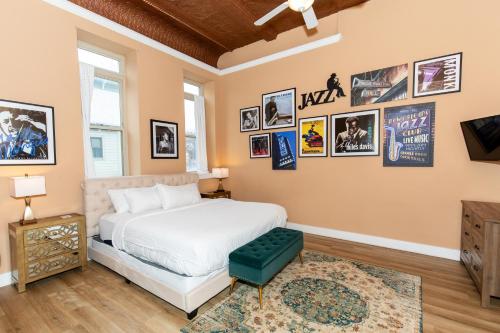 a bedroom with a bed and pictures on the wall at The Jazz Club Downtown Sandusky in Sandusky