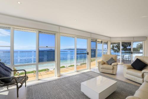 a living room with a view of the ocean at Villa Maris in Soldiers Point