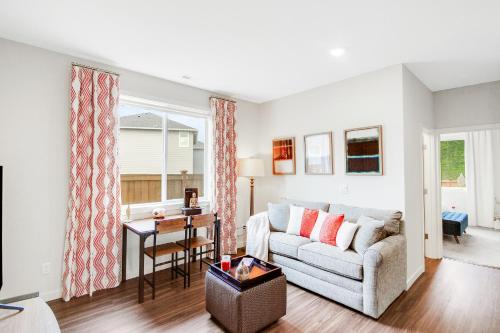 a living room with a couch and a table at Cozy Oasis in Port Orchard - Private 1BR Suite with Trails in Port Orchard