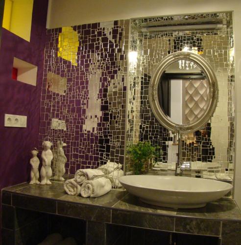 a bathroom with a sink and a mirror at Janus Boutique Hotel & Spa in Siófok