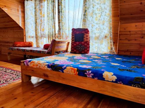 a bedroom with a bed and a chair and curtains at Solitude in the Himalayas in Darjeeling