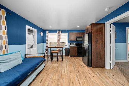 a blue room with a bed and a kitchen at Stylish Apartment Minutes from NRG and Med Center in Houston