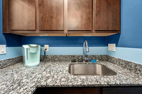 a kitchen counter with a sink and a trash can at Stylish Apartment Minutes from NRG and Med Center in Houston