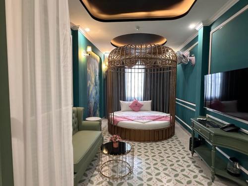 a room with a crib with a bed and a tv at New Pearl Hotel HCM in Ho Chi Minh City
