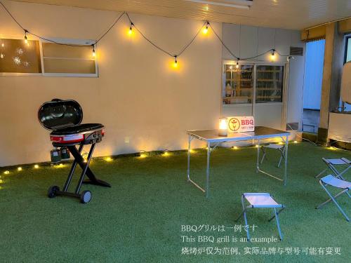 a room with a grill and a table and chairs at ザホテル湯沢オリエンタル in Yuzawa