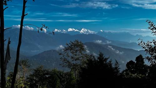a view of a mountain range with snow capped mountains at Solitude in the Himalayas in Darjeeling