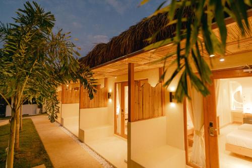 a house with a courtyard with a couch and trees at LEUX Hotel Alona Panglao in Panglao