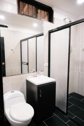 a bathroom with a toilet and a sink and a shower at Hotel Campestre Playa Primavera in San Carlos