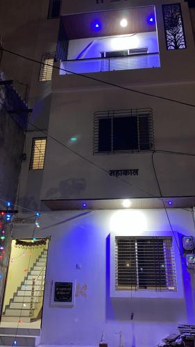 a building with blue lights on the side of it at Jhankar home stay in Ujjain