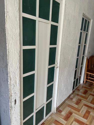 a door with glass panels on a wall at Casa de campo in Cuautla Morelos