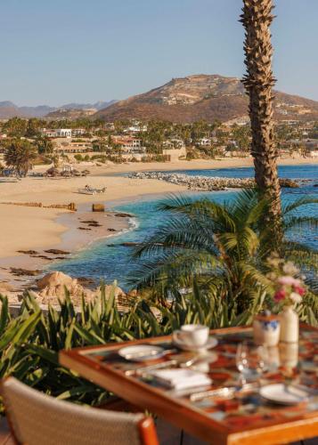 a table with a view of the beach and the ocean at One&Only Palmilla in San José del Cabo