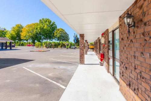 an empty parking lot with a brick building at Lavana Motel in Hastings