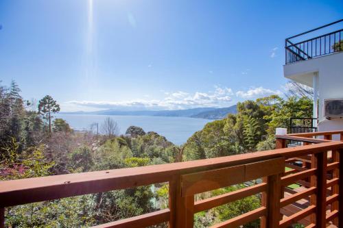 a view of the water from a balcony of a house at 真鶴海の見える古民家風ジャパニーズルームapartment Hotel途乃中W2 in Manazuru