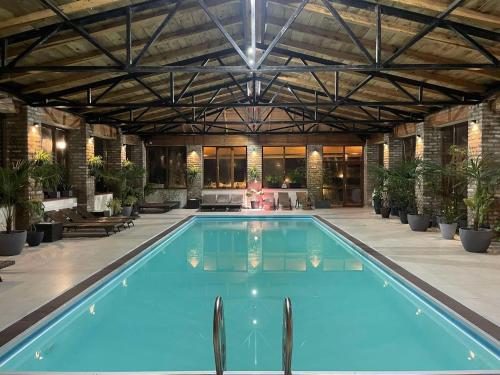 a large swimming pool in a large building with at Matilda Village in Tʼelavi