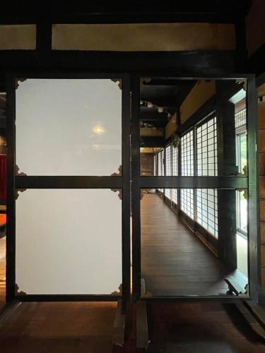 a view from the inside of a building through a window at 古民家ウェルネスビレッジ青梅 成木の社 Nariki no Mori in Ome