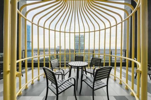 a room with a table and chairs on a balcony at Alinea Luxury Condominiums, Shah Alam - Smarthome in Shah Alam