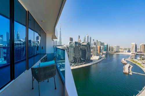 balcón con banco y vistas al río en Kasco Homes Waves Tower Business Bay, en Dubái