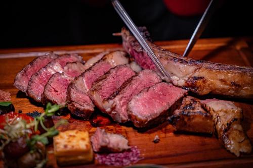 a bunch of meat on a wooden cutting board at Bangkok Marriott Hotel Sukhumvit in Bangkok