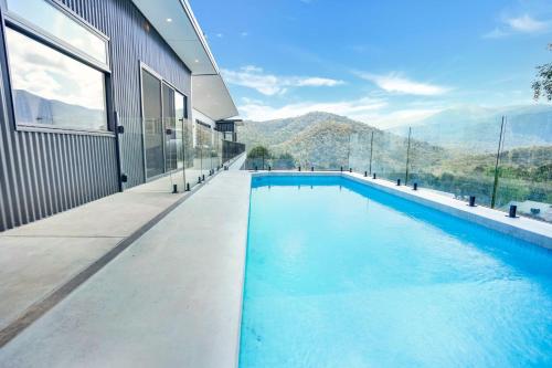 a swimming pool with a view of the mountains at Tanderra - Pool - Sleeps 12 in Merrijig