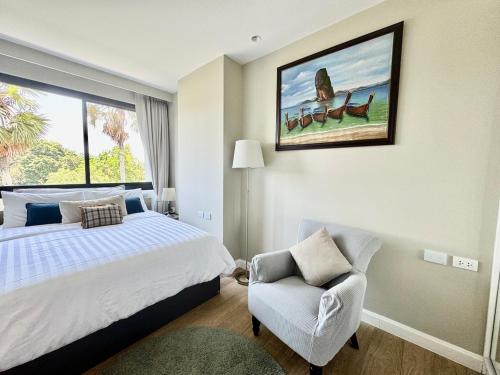 Un dormitorio con una cama, una silla y una ventana en Diamond apartaments 700m BangTao beach, en Bang Tao Beach