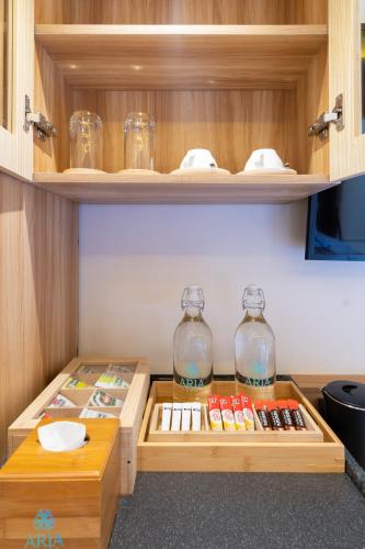 a cabinet with two glass jars and a shelf with books at ARIA Beach, Ukulhas in Ukulhas