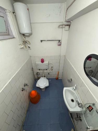 a bathroom with a toilet and a sink at Gaurav Retreat By StayApart in Darjeeling