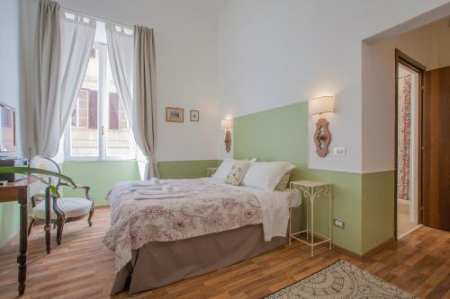 a green and white bedroom with a bed and a window at Babbo Guest House in Rome