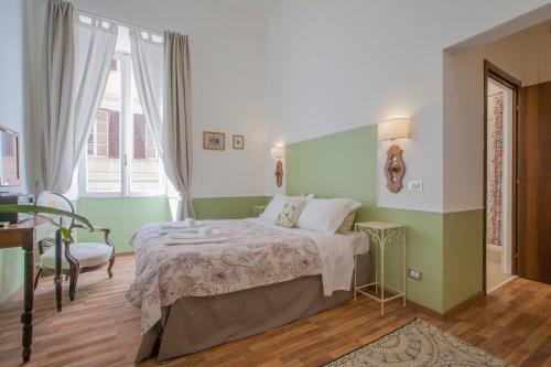 - une chambre verte et blanche avec un lit et une fenêtre dans l'établissement Babbo Guest House, à Rome