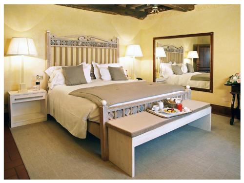 a bedroom with a large bed and a large mirror at Relais Todini - Residenza d'epoca - Luxury Historic house in Todi