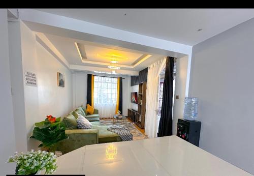 a living room with a couch and a table at Normad homes in Kisii