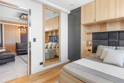 a bedroom with a bed and a living room at Nautica Residences Hillarys in Perth