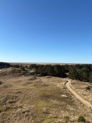 a road on the side of a hill with trees at Großzügiges Apartment in Strandnähe im Herzen St. Peter-Ordings in Sankt Peter-Ording